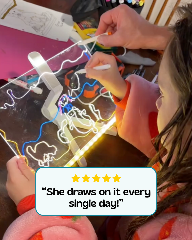 Child enjoying a glowing drawing board